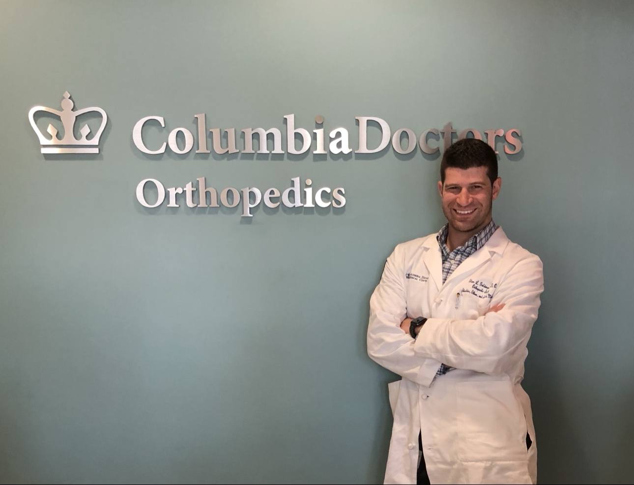 Dr. Elan Goldwaser in a white coat