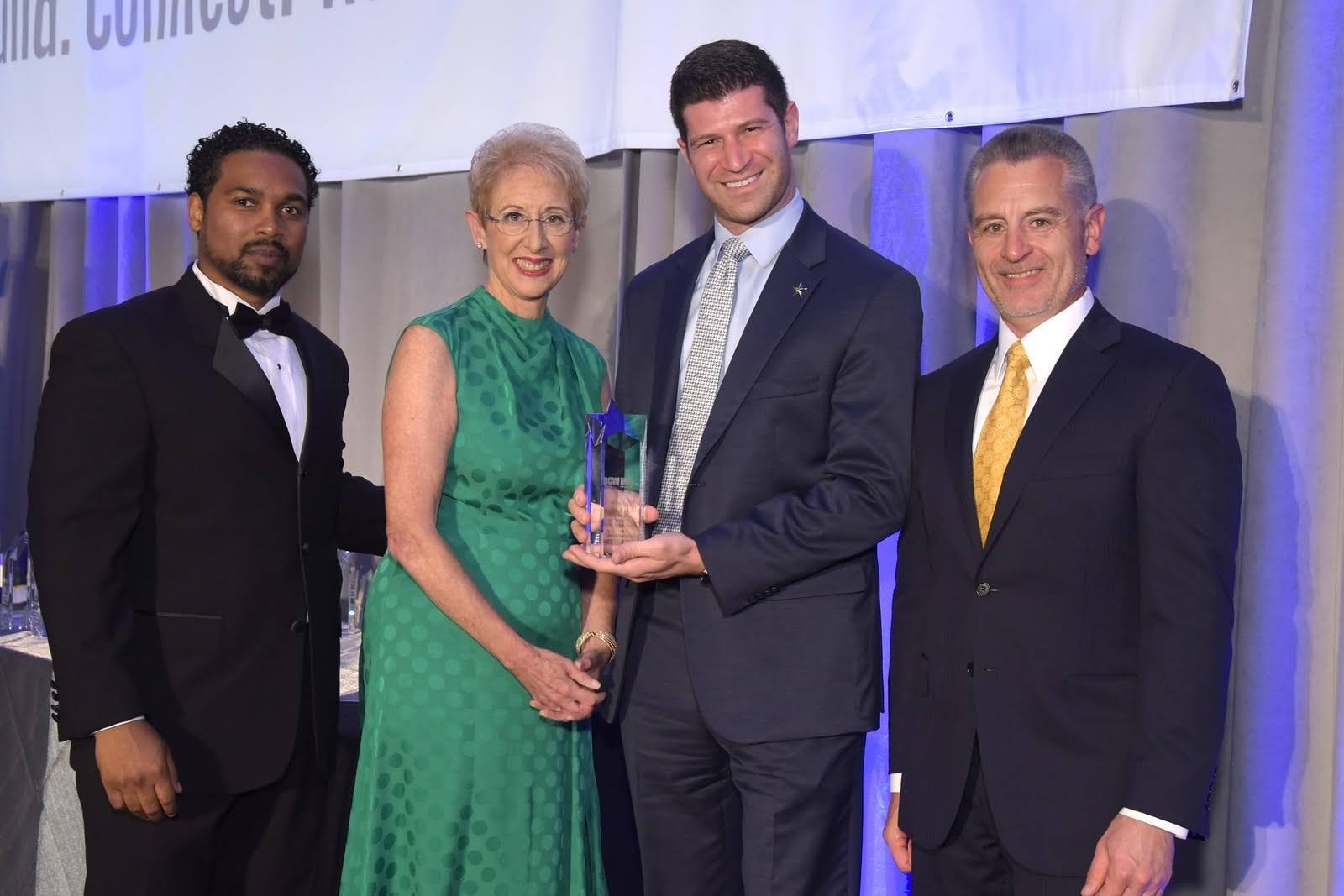 Dr. Goldwaser on stage receiving an award in Connecticut