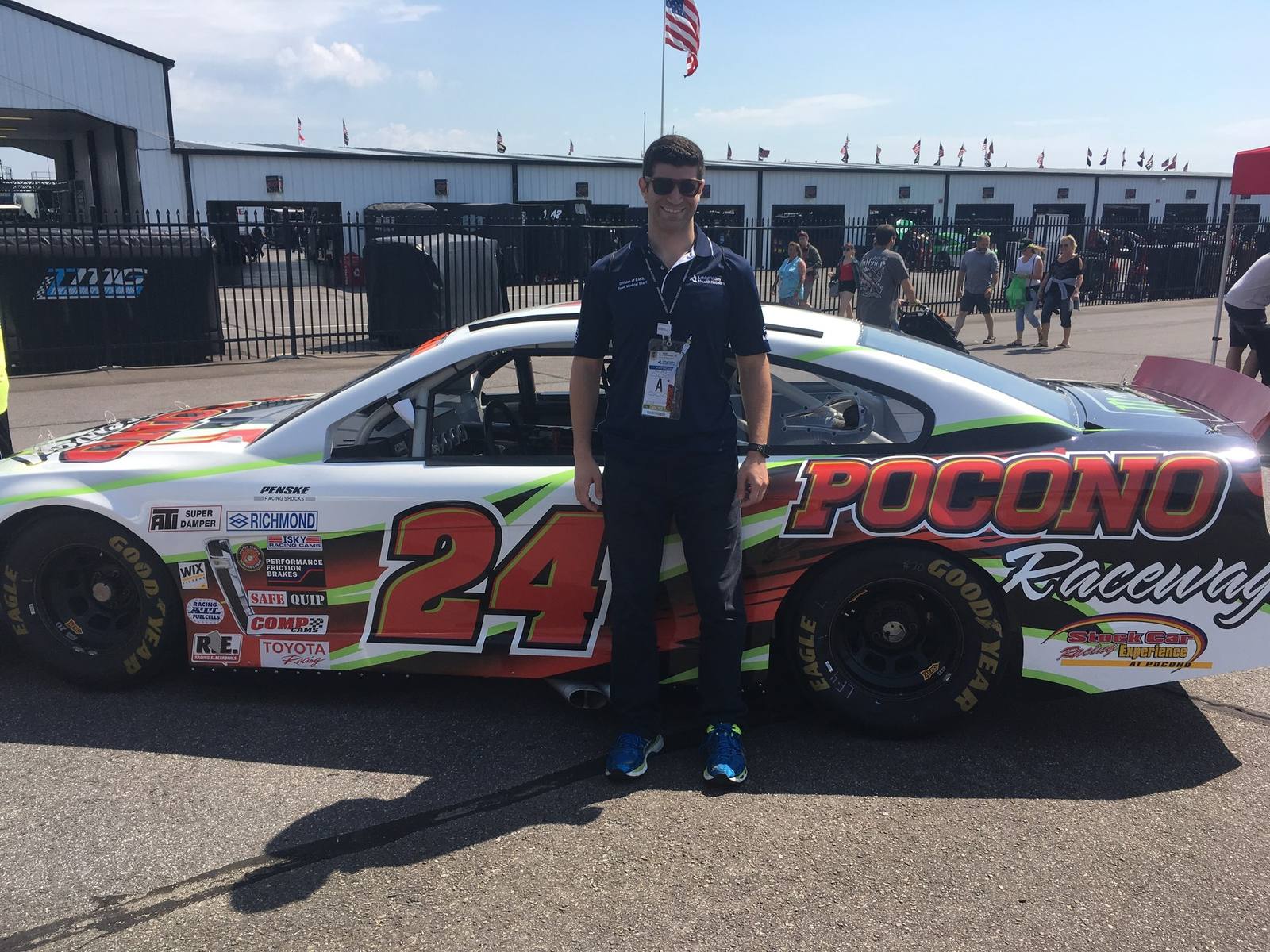 Dr. Goldwaser beside a race car at Pocono Raceway